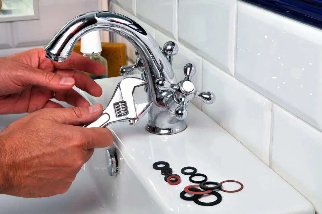 Plumber performing maintenance on a bathroom faucet in Port Orange