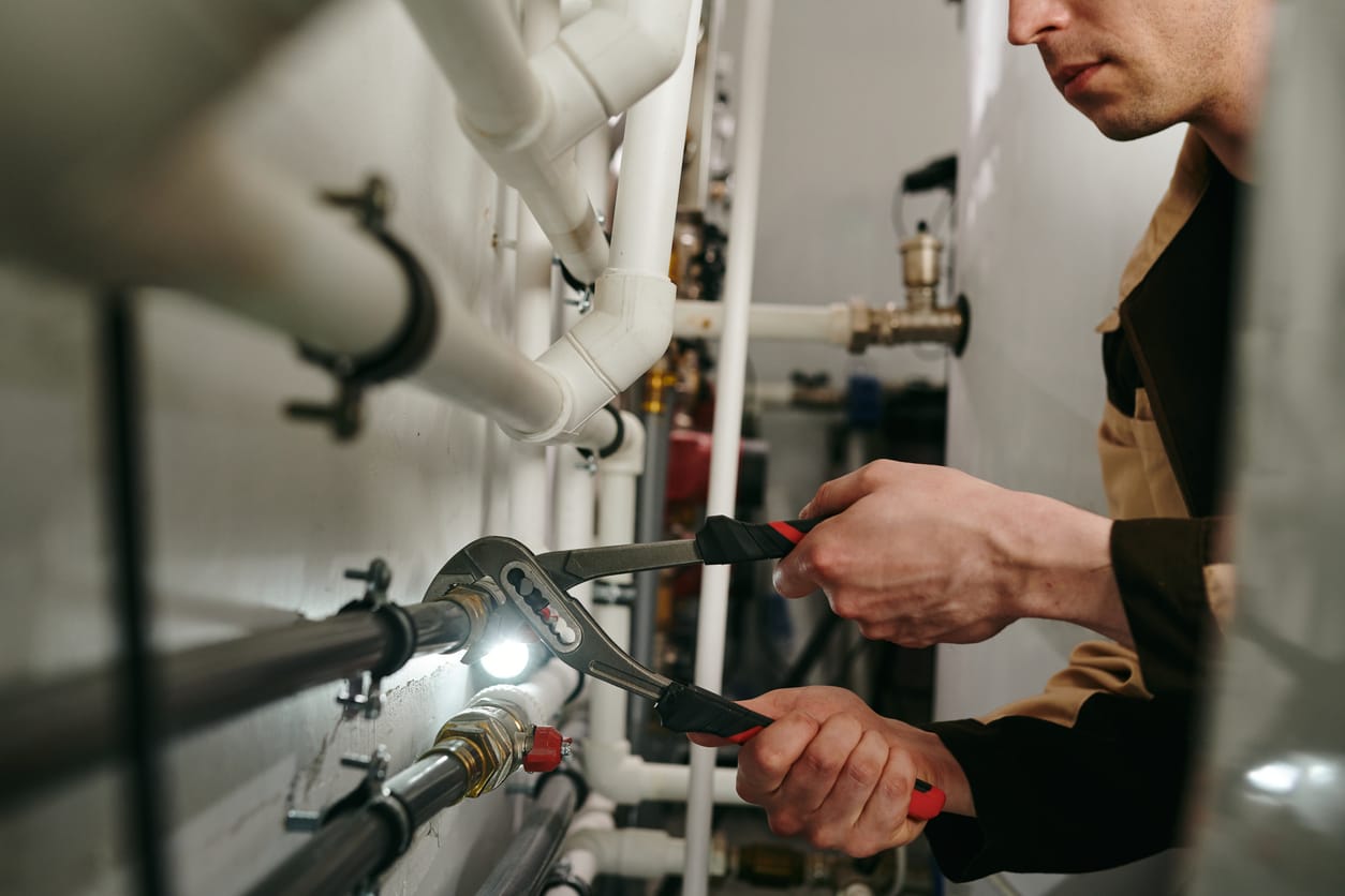 Plumbers maintaining commercial plumbing pipes in Port Orange