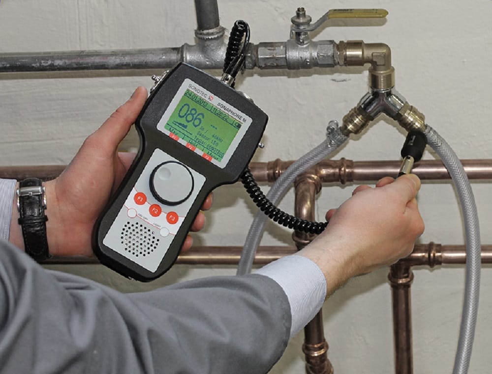 Plumber testing pipes with electronic leak detection equipment in Port Orange