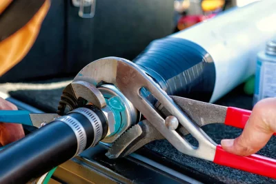 Technician tightening an industrial pipe connection in Port Orange