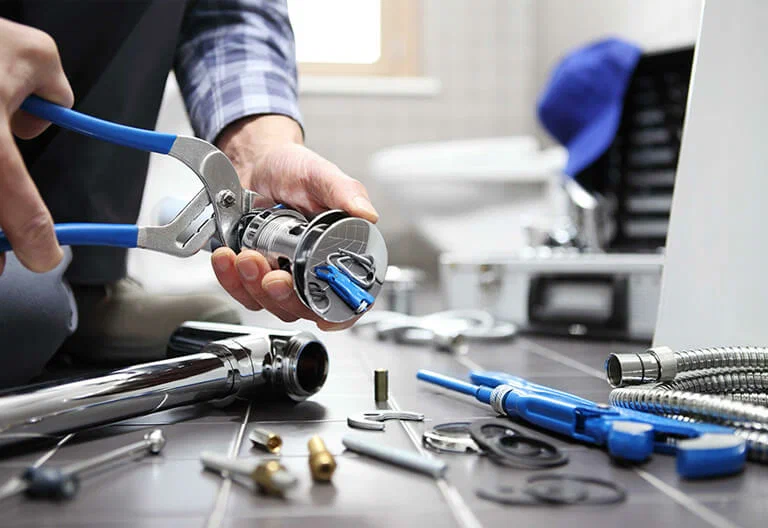 Technician repairing a plumbing fixture with professional tools in Port Orange