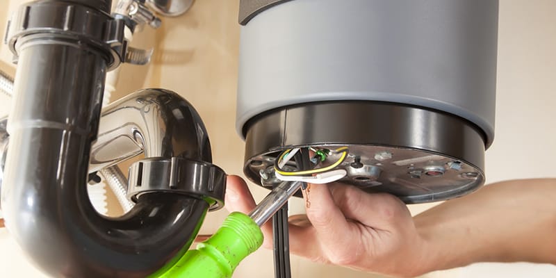 Technician repairing the heating element of a water heater in Port Orange