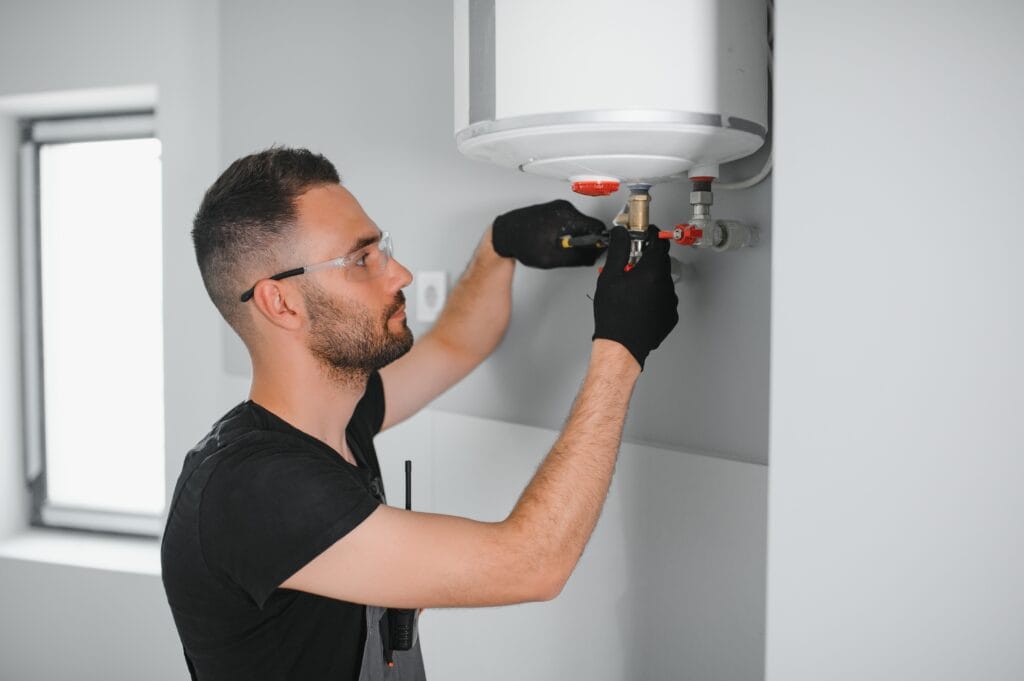 Technician performing water heater maintenance in Port Orange